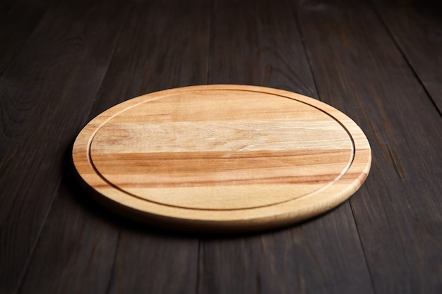 Photo cutting board from beech wood is on brown table