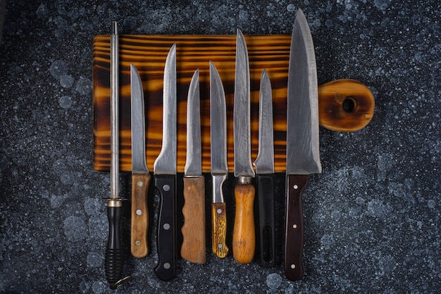 Cutting board and kitchen knives on the table.