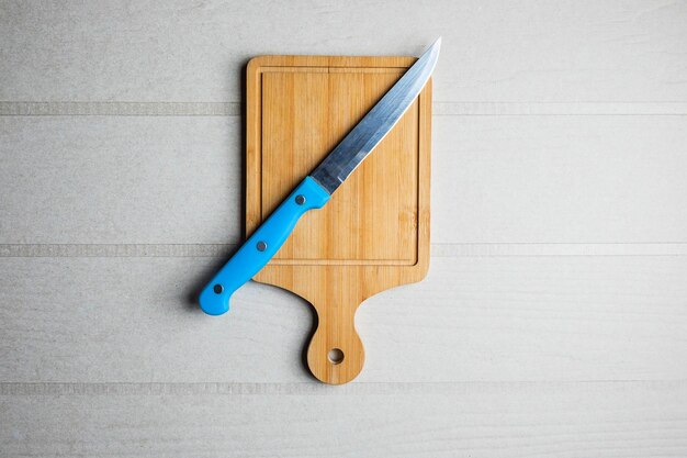 Cutting board and a knife on the table