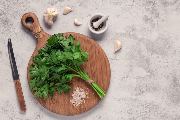 Cutting board parsley on a concrete table