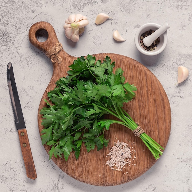 Cutting board parsley on a concrete table