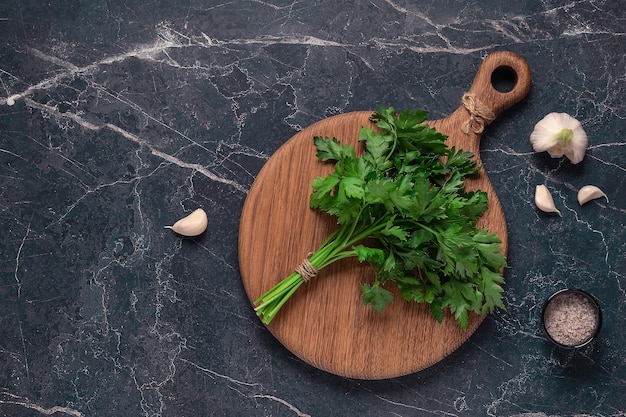 Cutting board parsley on a marble table