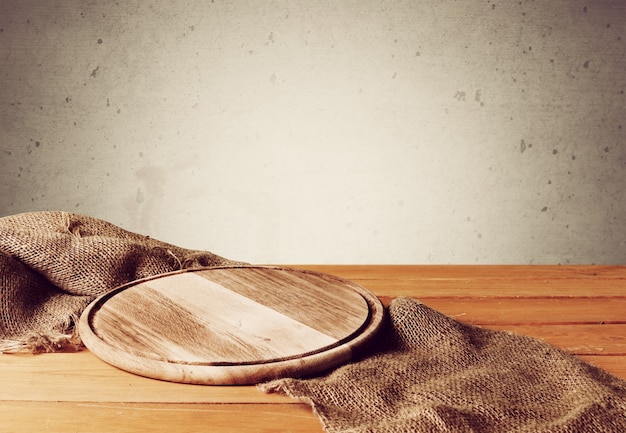 Cutting board on sackcloth, close-up view