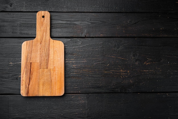 Cutting board set, on black wooden table background, top view flat lay , with copy space for text or your product