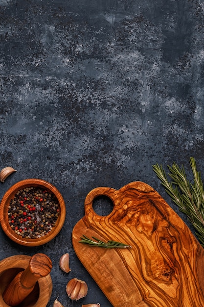 Cutting board and spice for cooking on a dark background