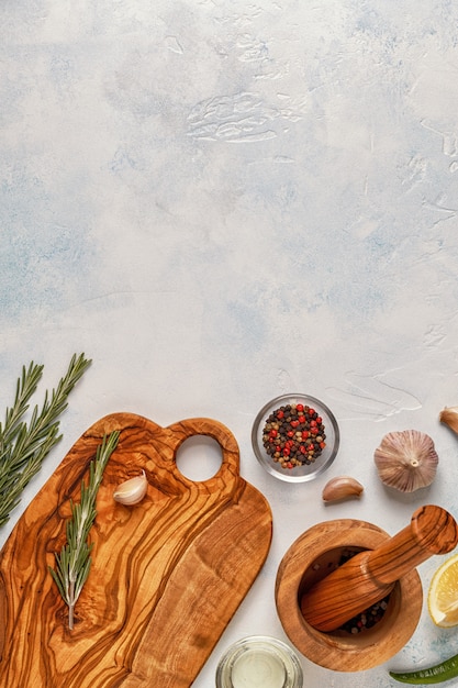 Cutting board and spices for cooking on a light background