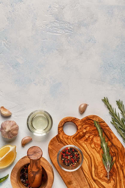 Cutting board and spices for cooking on a light background