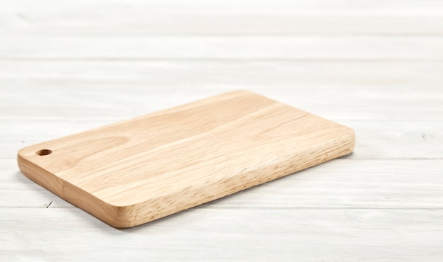 Cutting board top view on wooden background