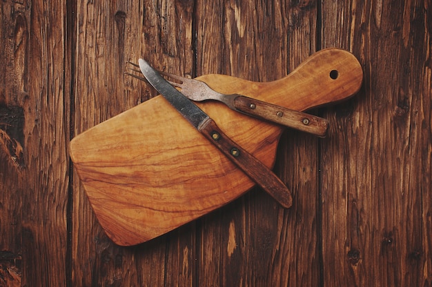 Cutting board on the vintage wooden background
