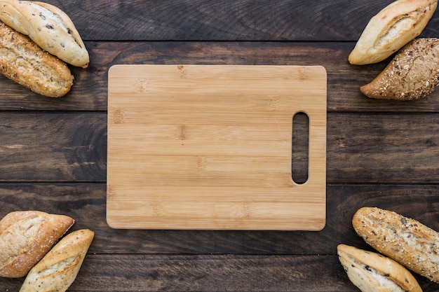 Cutting board with bread on table