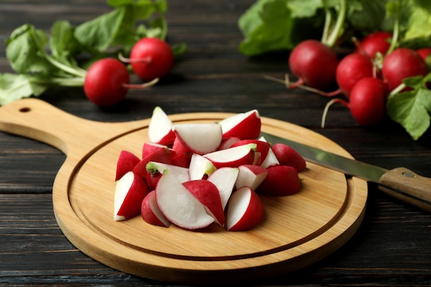 Cutting board with chopped radish on wooden