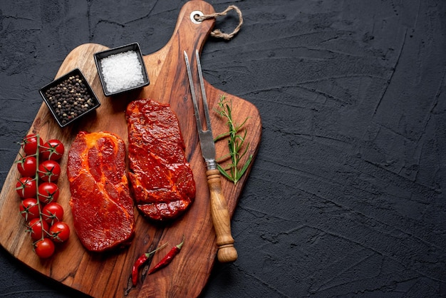 A cutting board with meat and spices on it