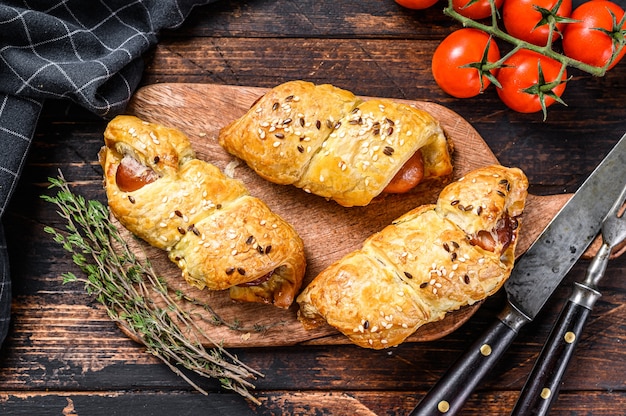 Cutting board with sausage rolls  in the dough