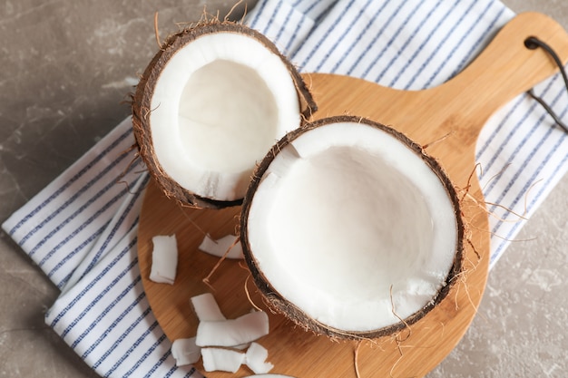 Cutting board with split coconut on table