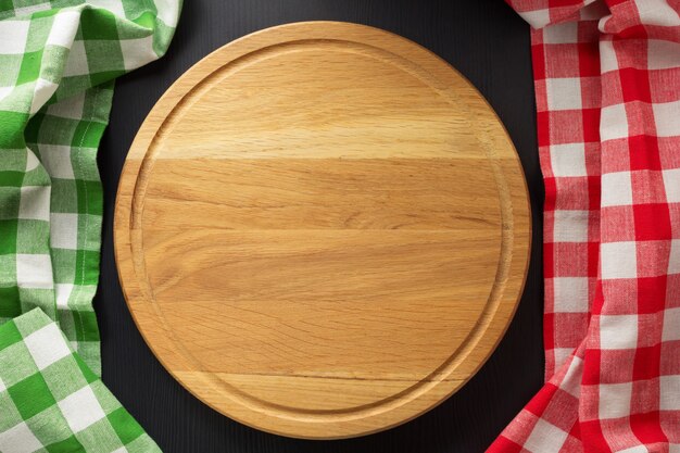 Cutting board at wooden table surface