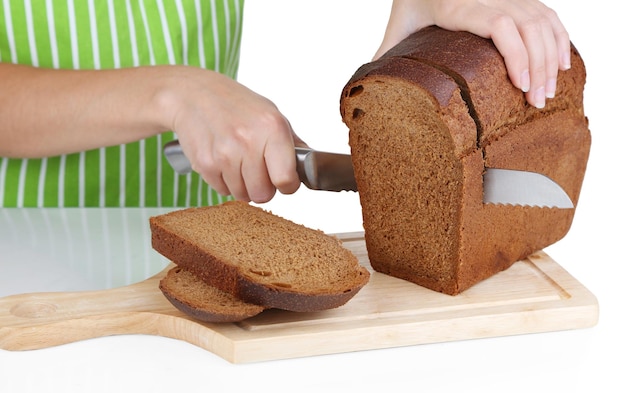 Cutting bread on wooden board isolated on white