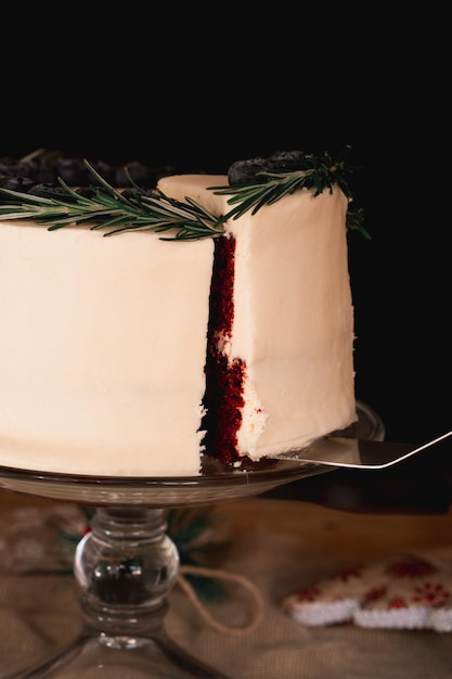 Cutting a cake, shot to detail without people on black background.