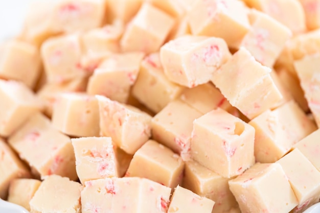 Cutting candy cane fudge into small cubes.