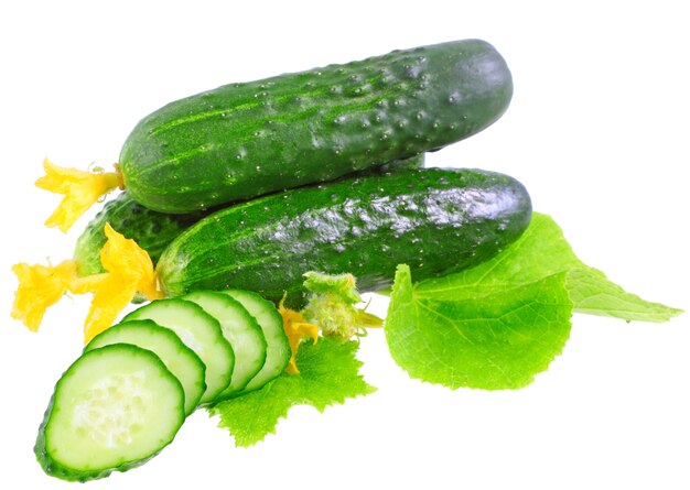 Cutting cucumbers on  with green leaf and yellow blossom cluster. Isolated over white.