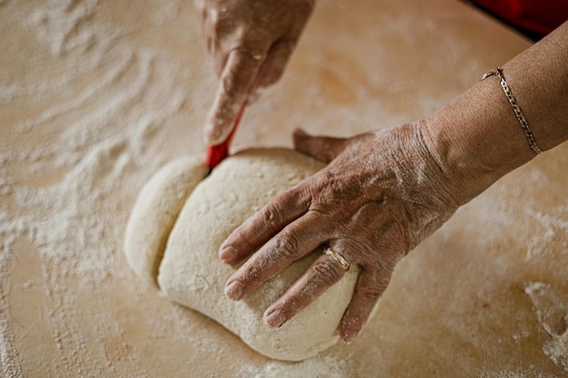 Cutting dough to make gnocchi - preparation of home-made food - cook cutting dough