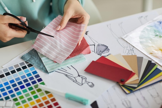 Photo cutting fabric in tailors studio