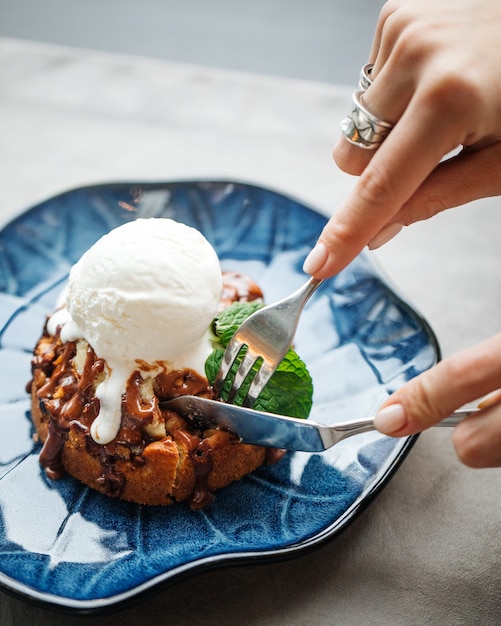 Cutting italian pie with ice cream and chocolate