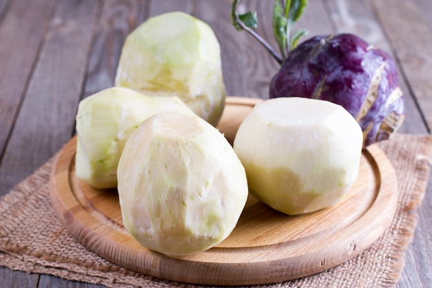 Cutting a kohlrabi on a wooden table