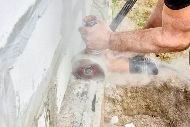 Cutting masonry with angle grinder power tool for cut concrete with silicon carbide wheels