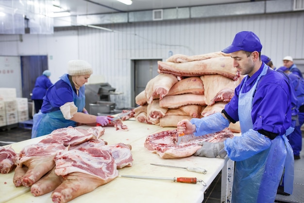 Cutting meat in slaughterhouse