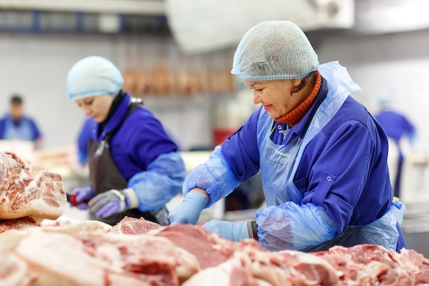 Cutting meat in slaughterhouse