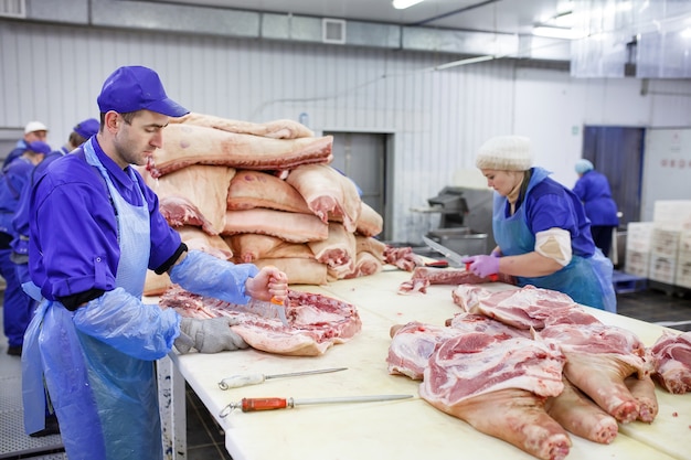 食肉処理場で肉を切る。