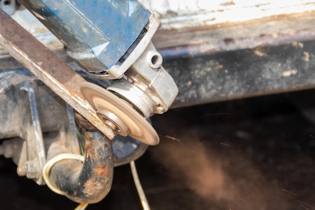 Cutting metal with angle grinder close-up