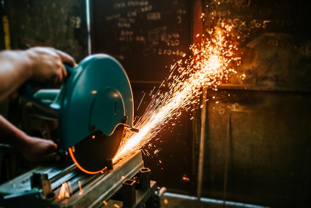 Cutting a metal with mitre saw with sharp circular blade.