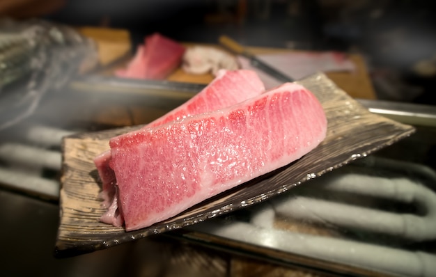 Cutting of otoro from blue fin tuna for sashimi.