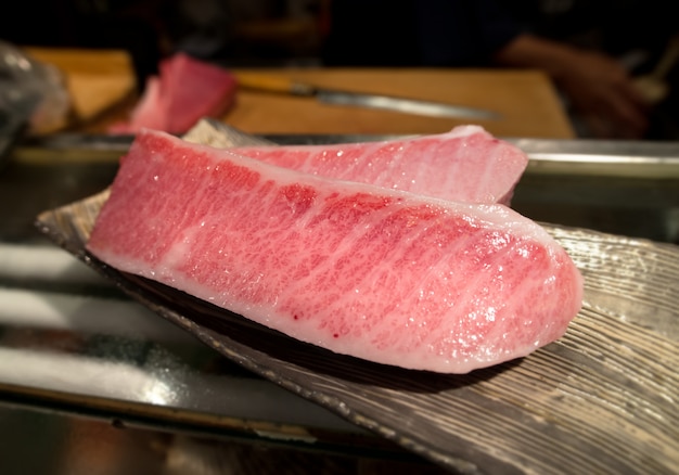 Cutting of otoro from blue fin tuna for sashimi.