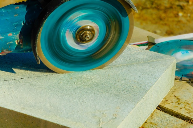 Cutting paving slabs with a disk.