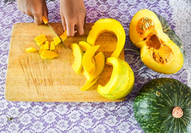 cutting pumpkin on cooking board