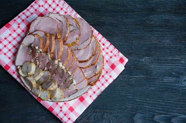 cutting sausages and cured meat on the holiday table