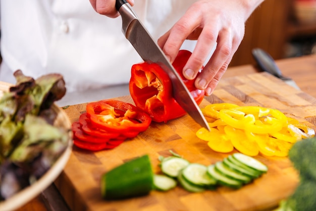 cutting vegetables on wooden table