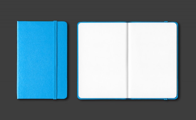 Cyan blue closed and open notebooks isolated on black