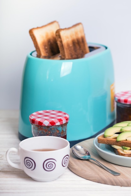 Cyan color toaster on a wooden background