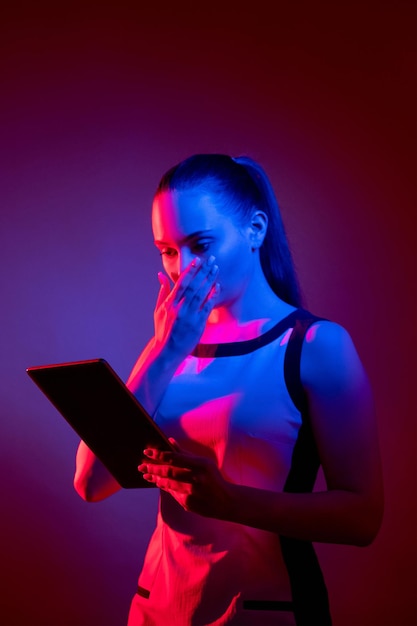Cyber attack digital scam scared neon woman tablet