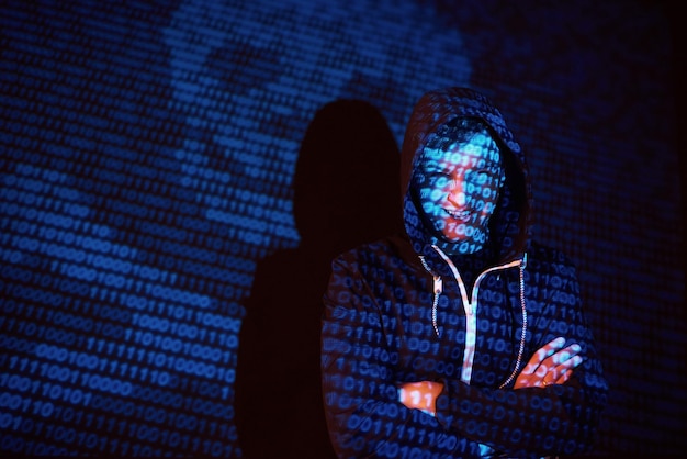 cyber attack with unrecognizable hooded hacker using virtual reality digital glitch effect