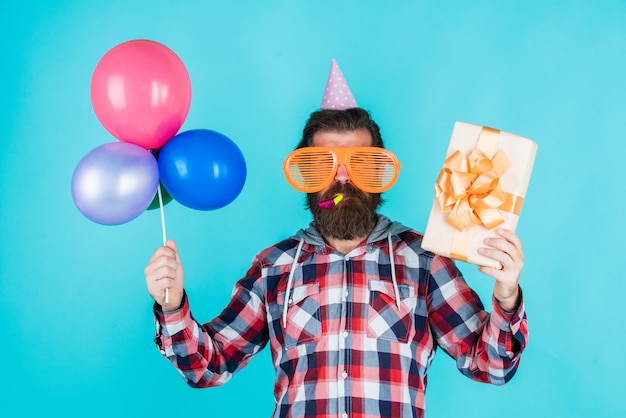 Cyber monday. happy birthday to you. male holiday celebration. bearded guy with party balloons and gift box. unshaven brutal man with beard celebrate business success. express pure happiness.