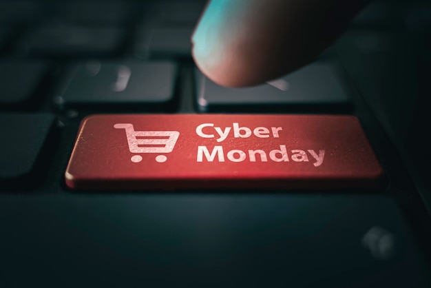 Cyber Monday and shopping trolley symbol on notebook keyboard Online shopping at a discount Sale day in online store