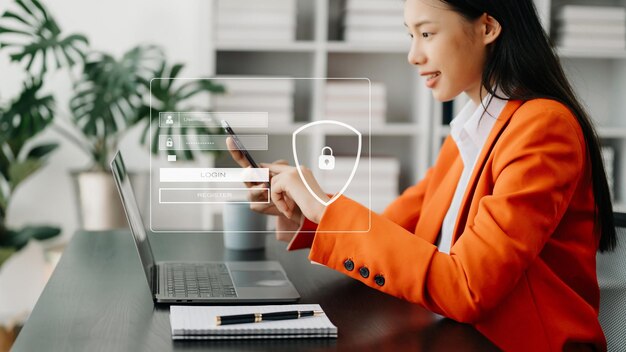 Photo cyber security concept login user identification information security and encryption secure access to user's personal information asian woman using smart phone and tablet in office