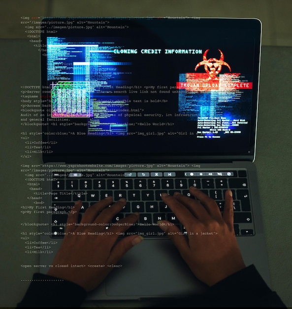 サイバーセキュリティ犯罪と、ウェブサイトのプログラミングまたはハッキング中にラップトップで手入力する詐欺サイバー攻撃と、暗闇の中で情報やデータテクノロジーを盗むためにコンピューター上でコーディングする男性ハッカー