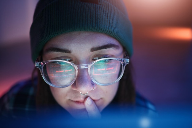 Cyber security ransomware and woman hacker working on a computer in the basement at night for phishing Database password and malware with a female coder hacking a digital transformation network