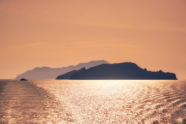Cyclades islands silhouettes in aegean sea