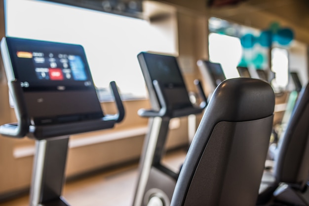 Cycle machines in a gym with beautiful light from the window treadmill